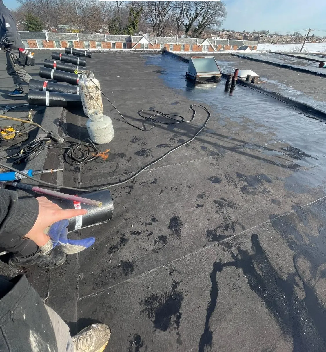 Before: the worn, patched flat roof