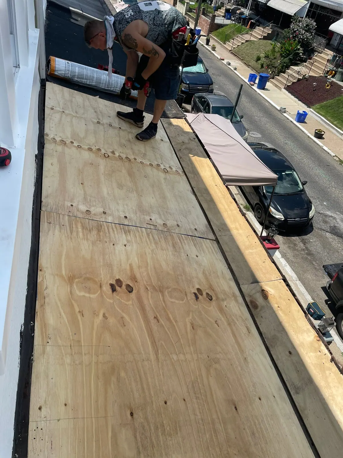 New plywood decking going down during a porch roof tear-off